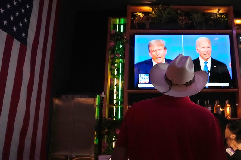 The presidential debate was watched by people at venues across the US (Ross D Franklin/AP)