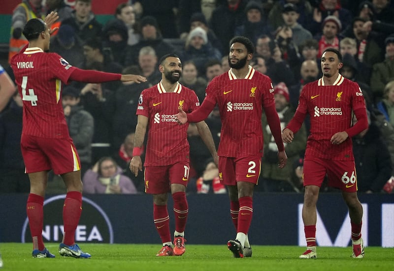 Mohamed Salah, second left, celebrates after scoring Liverpool’s third goal against Leicester