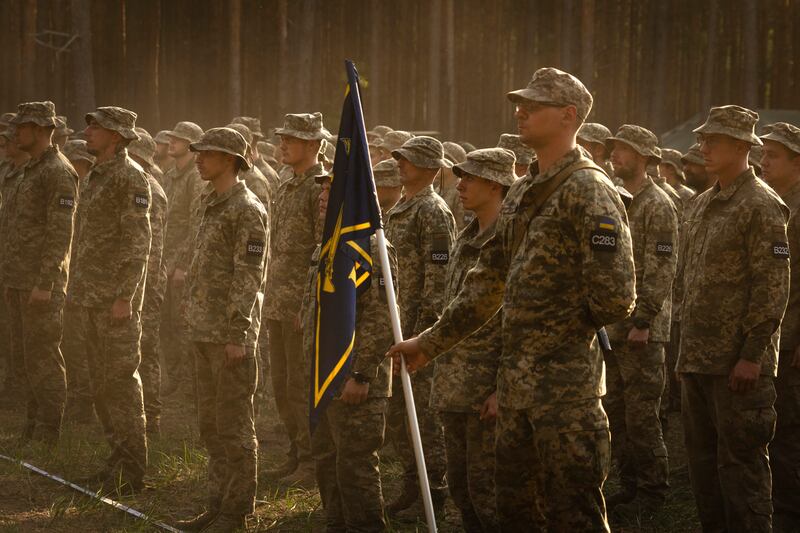 Newly recruited soldiers attend a ceremony to mark the end of their training (AP)