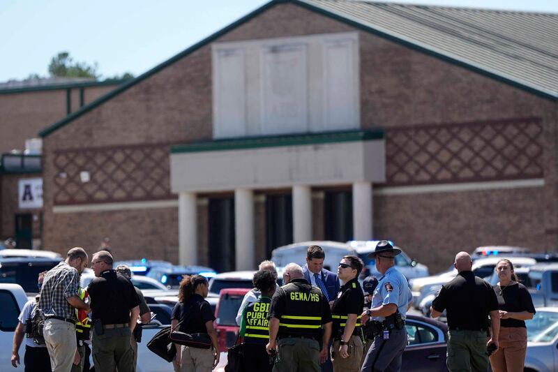 Police gather outside Apalachee High School after the shooting (Mike Stewart/AP)