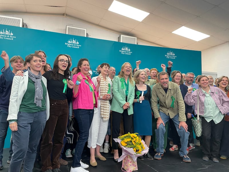 Sian Berry and Green Party supporters celebrate at the Portslade Sports Centre after winning the seat in the Brighton Pavilion constituency