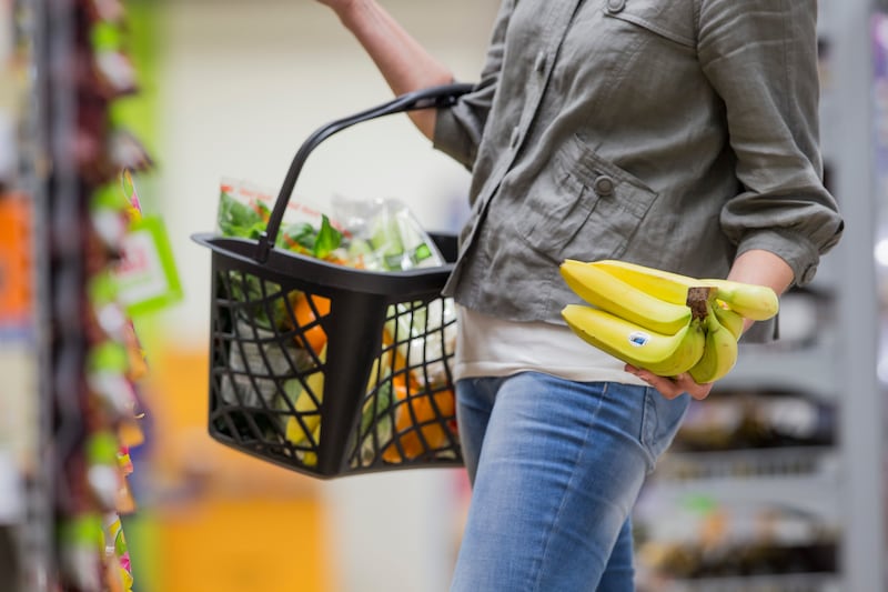 A supermarket shopper chooses a bunch of Fairtrade bananas as the organisation thanks British consumers for their support of low-income farmers. (Fairtrade)