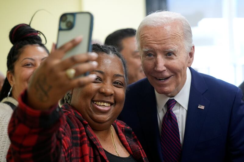 President Joe Biden takes a photo as he visits CJ’s Cafe in Los Angeles (AP Photo/Manuel Balce Ceneta)