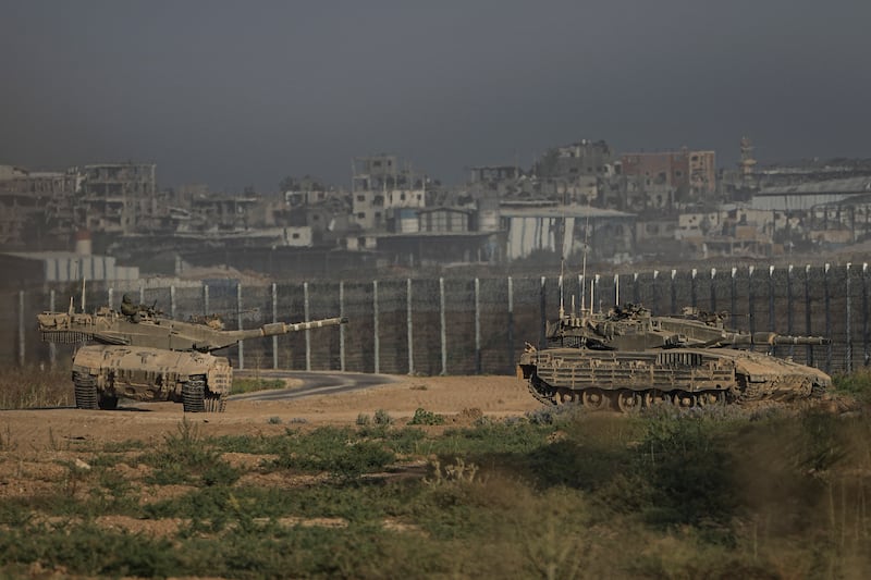 Israeli tanks stand near the Israel-Gaza border (Tsafrir Abayov/AP)