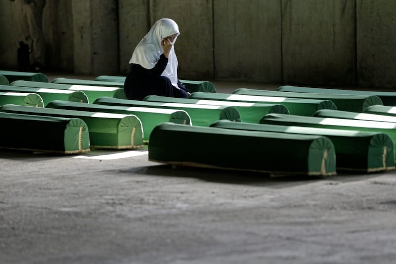 A Bosnian Muslim woman cries at the coffin of a relative at the Srebrenica memorial centre at Potocari. Remains of newly identified victims of the genocide, many buried in mass graves, are regularly recovered. Picture by AP Photo/Amel Emric 