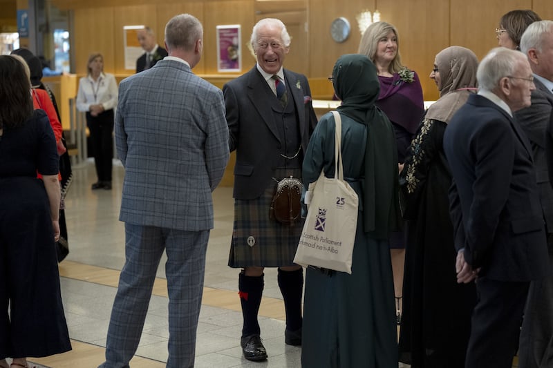 King Charles chatted to guests at a reception after a special ceremony to mark 25 years of the Scottish Parliament.