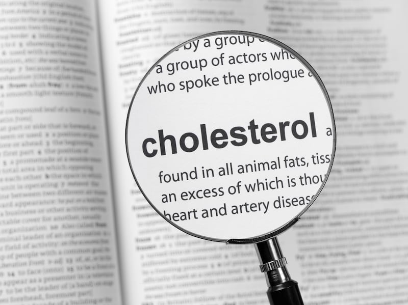 A magnifying glass highlighting the definition of cholesterol