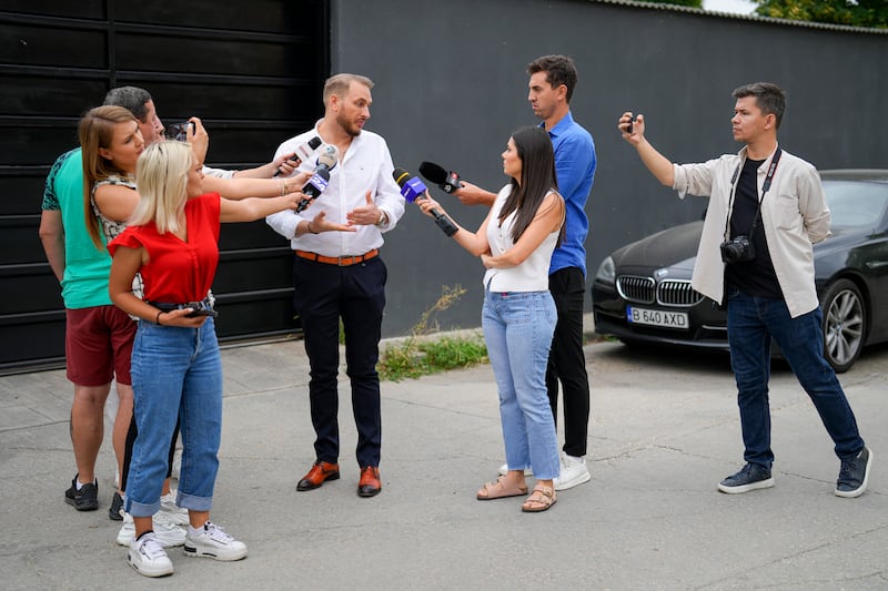 Andrew Tate’s lawyer Eugen Vidineac talks to the media during a search raid by the police on the outskirts of Bucharest (Vadim Ghirda/AP)