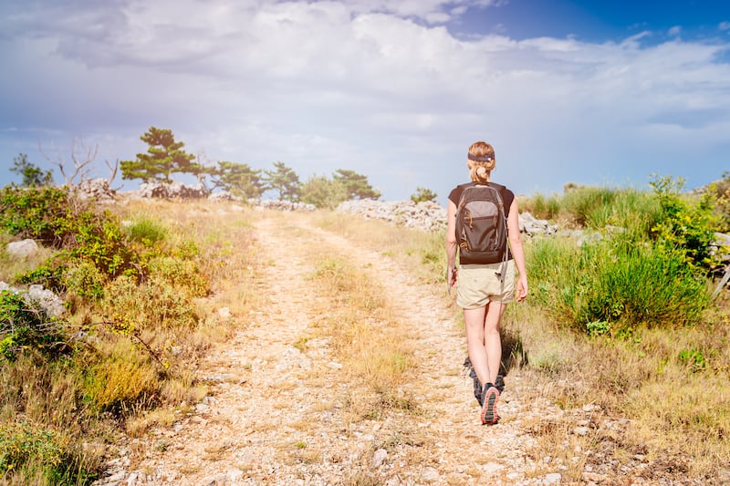 Woman walking along rocky path