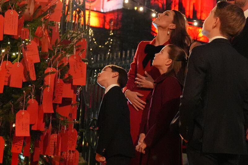 Kate looked at messages on the Kindness Tree with her children ahead of the service