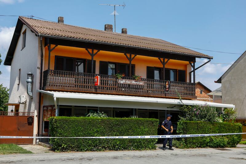 A police officer stands outside the cafe where the gunman was arrested, in Daruvar (Zeljko Puhovski/Cropix/AP)