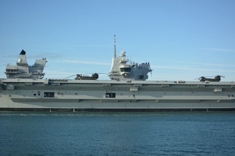 Two chinook helicopters are see on the flight deck of HMS Prince of Wales