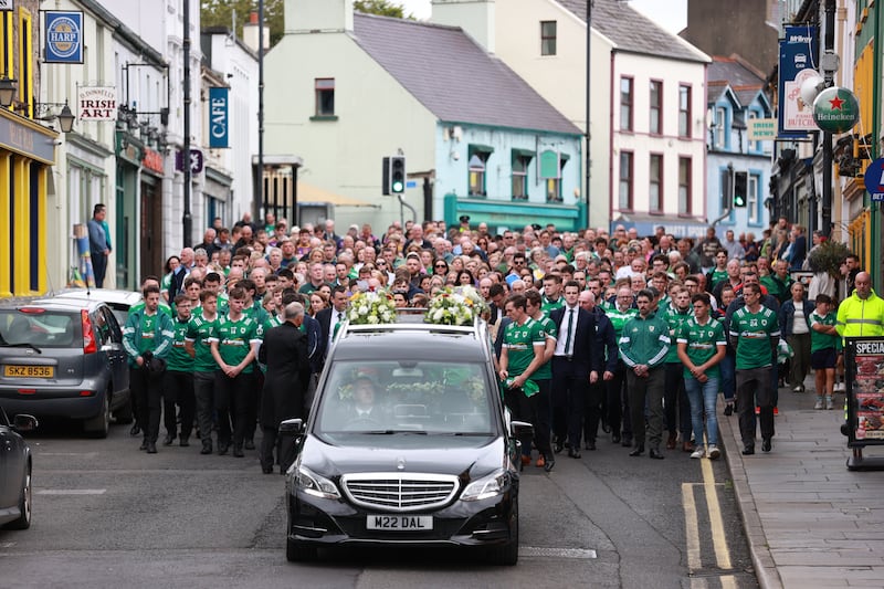 Mourners walk beside the hearse as the cortege travels to the funeral of Joseph Hegarty at St Patrick’s and St Brigid’s Church, Ballycastle, Co Antrim