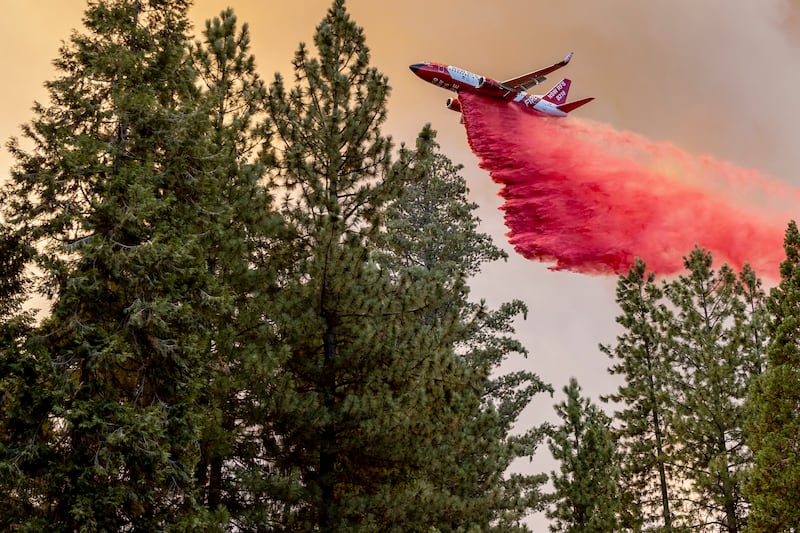 A firefighting plane releases retardant (Stephen Lam/San Francisco Chronicle/AP)