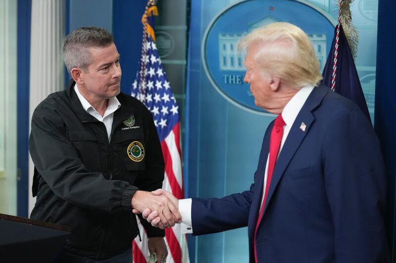 President Donald Trump shakes hands with transportation secretary Sean Duffy (Jacquelyn Martin/AP)