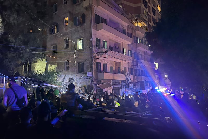 Residents and rescuers gather at the site of an Israeli airstrike in Beirut (Bilal Hussein/AP)