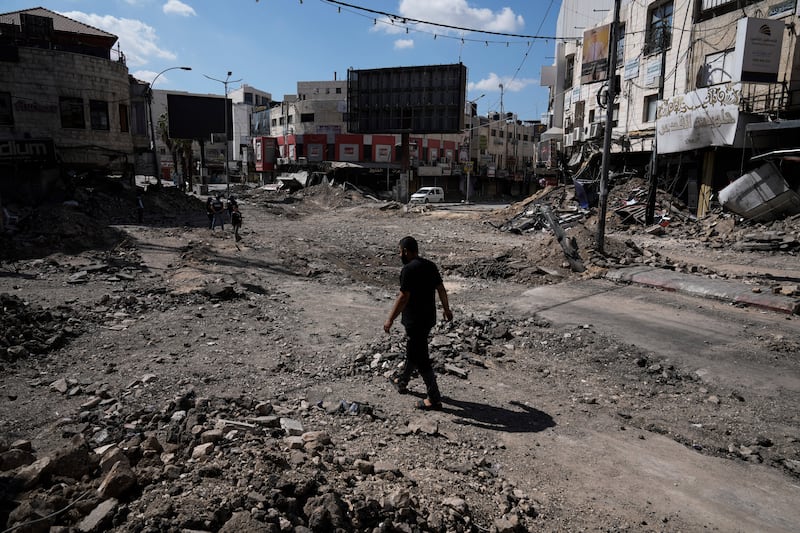 A man walks through rubble following an Israeli army raid in Jenin (Majdi Mohammed/AP)