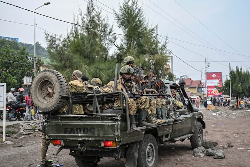 M23 rebels escort government soldiers and police who surrendered to an undisclosed location in Goma (Moses Sawasawa/AP)