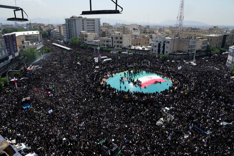 Iranians attend a funeral ceremony for the late President Ebrahim Raisi and other victims of the crash in Tehran (AP)