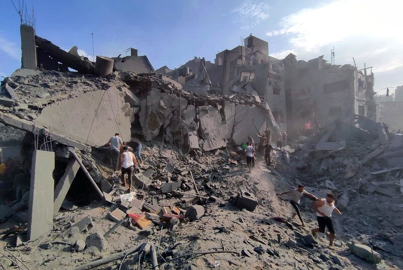 Palestinians inspect the damage of buildings destroyed by Israeli air strikes on Jabaliya refugee camp (Abdul Qader Sabbah/AP)