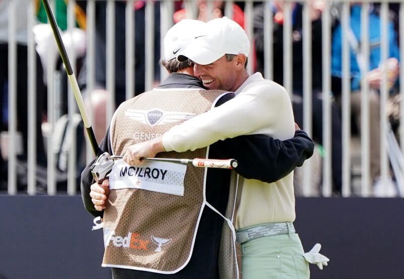 McIlroy celebrates the winning putt with caddie Harry Diamond on day four of the 2023 Genesis Scottish Open