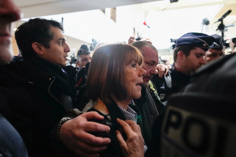 Gisele Pelicot is surrounded as she arrives at court (Lewis Joly/AP)