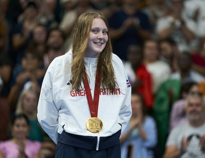 Poppy Maskill on the podium after winning the gold medal in the women’s 100m butterfly