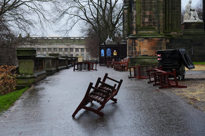 Wooden park benches blown over by the winds from Storm Eowyn in Princes Street Gardens, Edinburgh