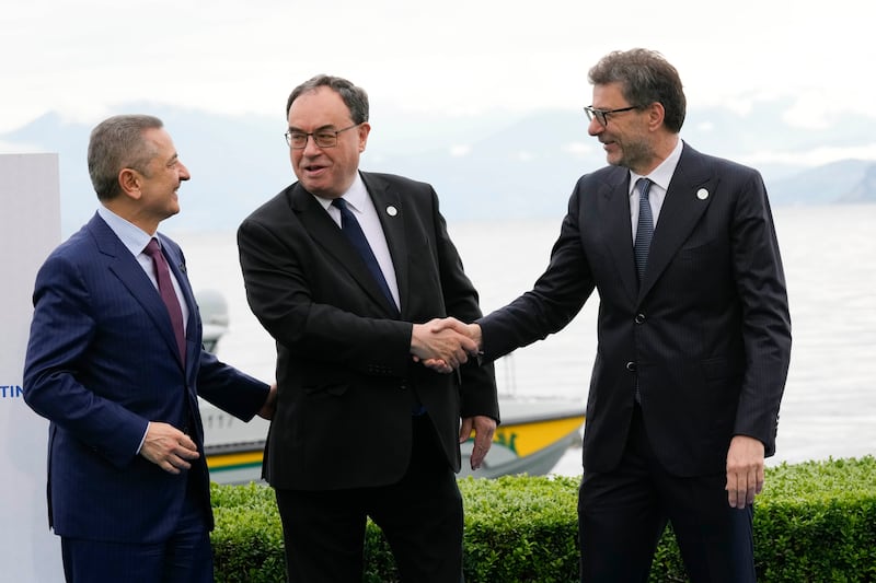 Andrew Bailey, governor of the Bank of England, centre, is welcomed by Italy’s finance minister Giancarlo Giorgetti, right, and Fabio Panetta governor of the Bank of Italy, at the G7 meeting in Stresa, northern Italy (Antonio Calanni/AP)