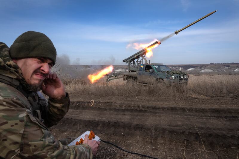 A Ukrainian officer fires a multiple launch rocket system towards Russian positions (Efrem Lukatsky/AP)