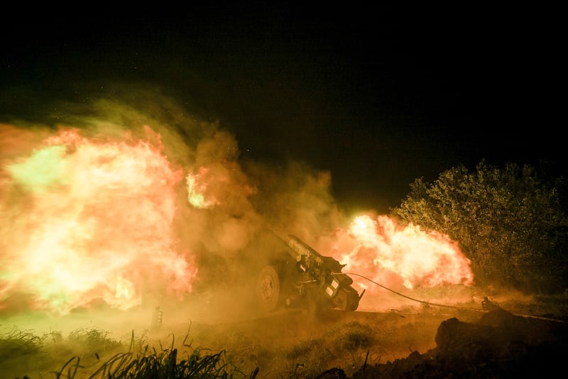 Ukrainian servicemen fire from a 122mm artillery cannon towards Russian positions in Kherson region, Ukraine, on Sunday (Marko Ivkov/AP)