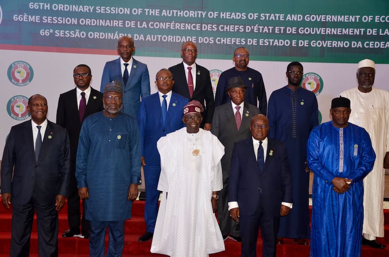 Nigeria’s President Bola Ahmed Tinubu, third from left, first row, poses for a group photo with other West African leaders, prior to the start of the Ecowas meeting, in Abuja, Nigeria, on Sunday (Olamikan Gbemiga/AP)