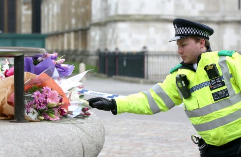 a police officer arranges flowers