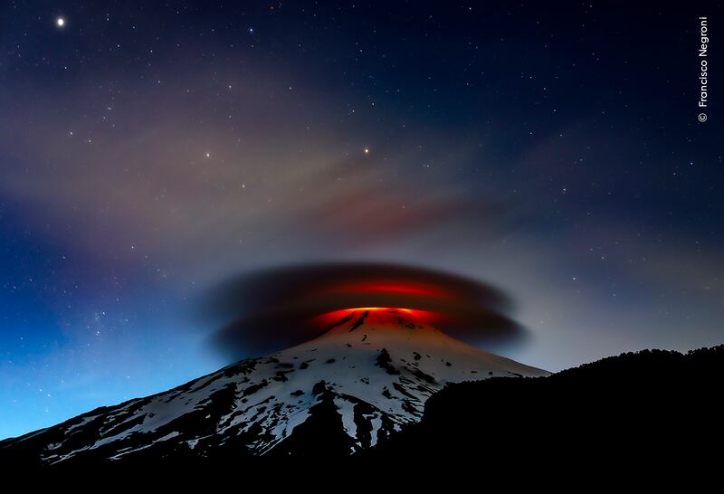 A double lenticular cloud is illuminated at nightfall by the lava emitted from the Villarrica volcano, Chile. (Francisco Negroni)