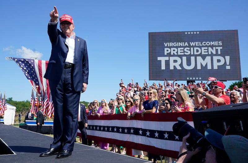 Republican presidential candidate Donald Trump waves to the crowd at a campaign rally in Virginia. Rudy Giuliani was a vocal supporter of the former president (AP Photo/Steve Helber)