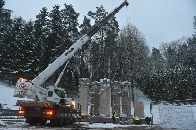 Workers dismantle the memorial of the Red Army Soldiers who died during the liberation of Vilnius from Nazi invaders during the Second World War at the Antakalnis Memorial Cemetery in Vilnius, Lithuania (AP)