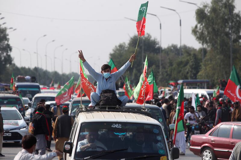 Supporters board into vehicles as they start a rally for Islamabad to demand Khan’s release (Muhammad Sajjad/AP)