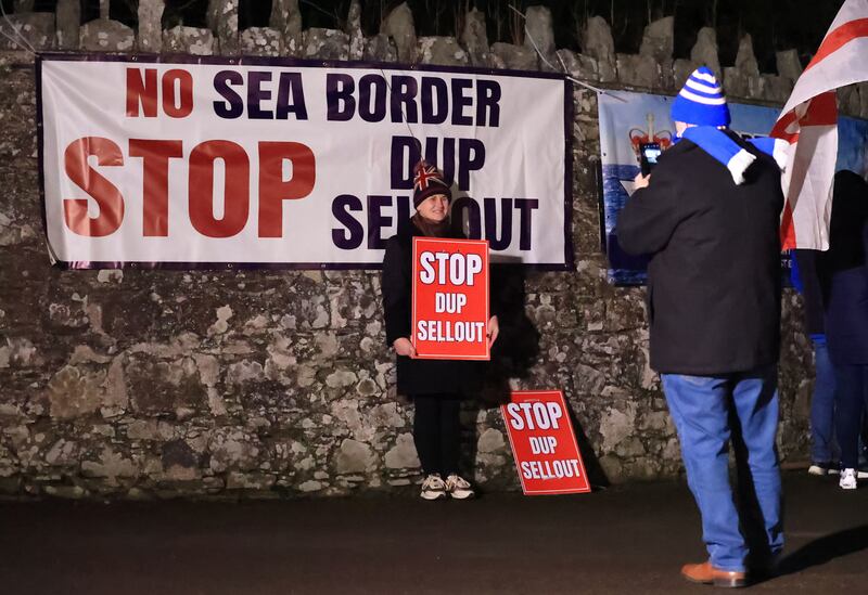 Protesters outside Larchfield Estate where the DUP are holding a private party meeting. PICTURE: LIAM MCBURNEY/PA