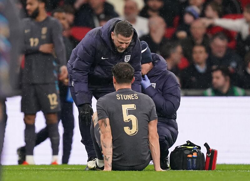 England’s John Stones receives treatment for an injury during the international friendly against Belgium at Wembley