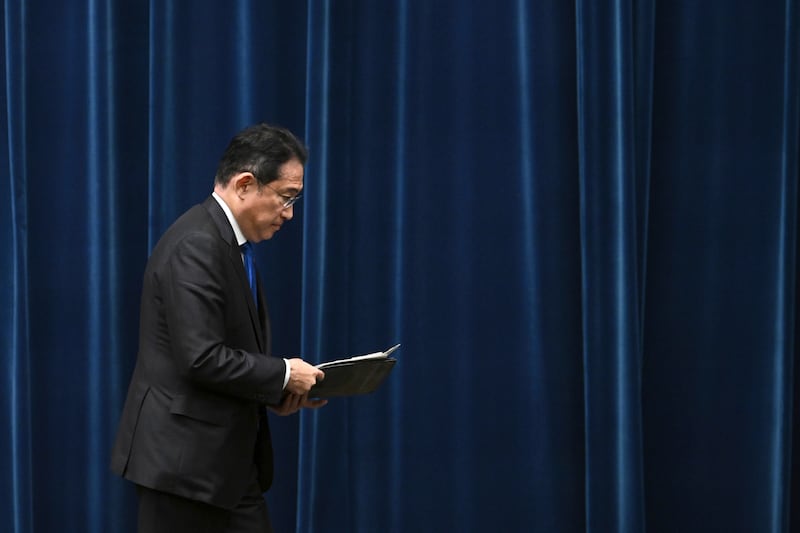 Japan’s Prime Minister Fumio Kishida leaves a press conference at his office in Tokyo after he announced he will not run (Philip Fong/AP)