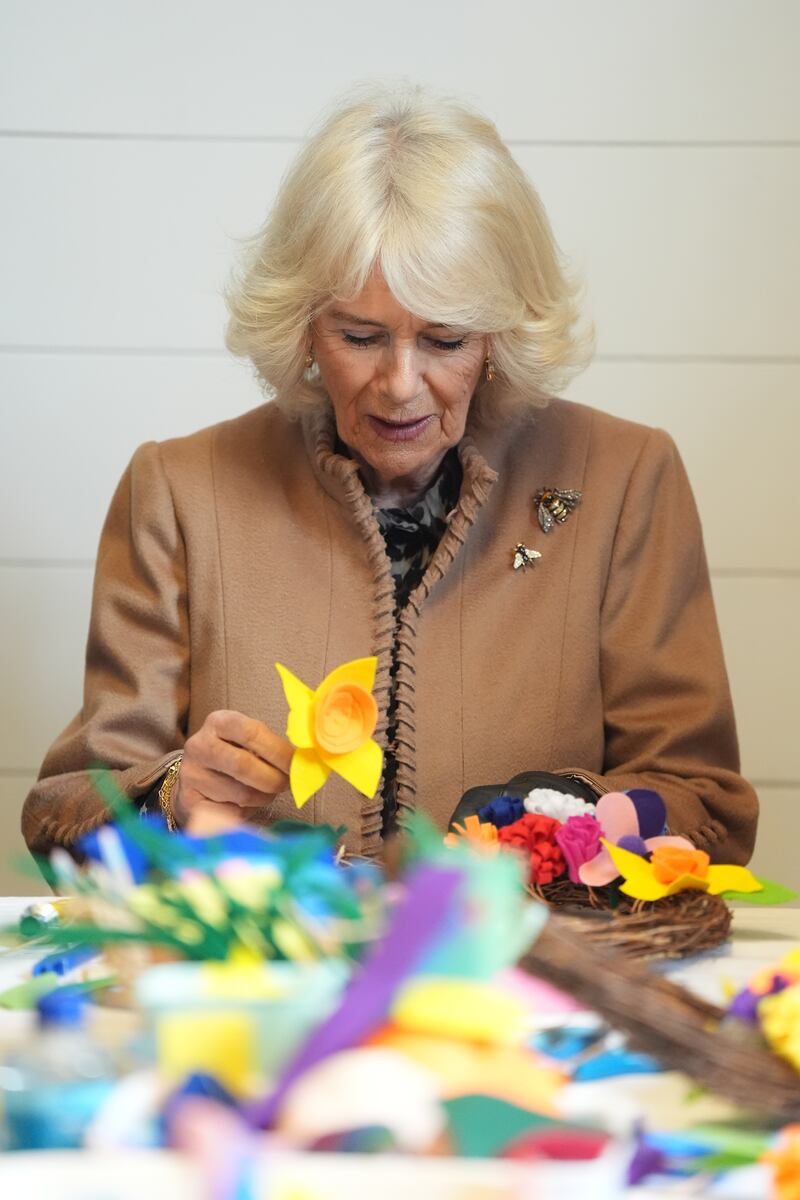 Queen Camilla tries her hand at crafting a spring wreath with members of the Royal Voluntary Service