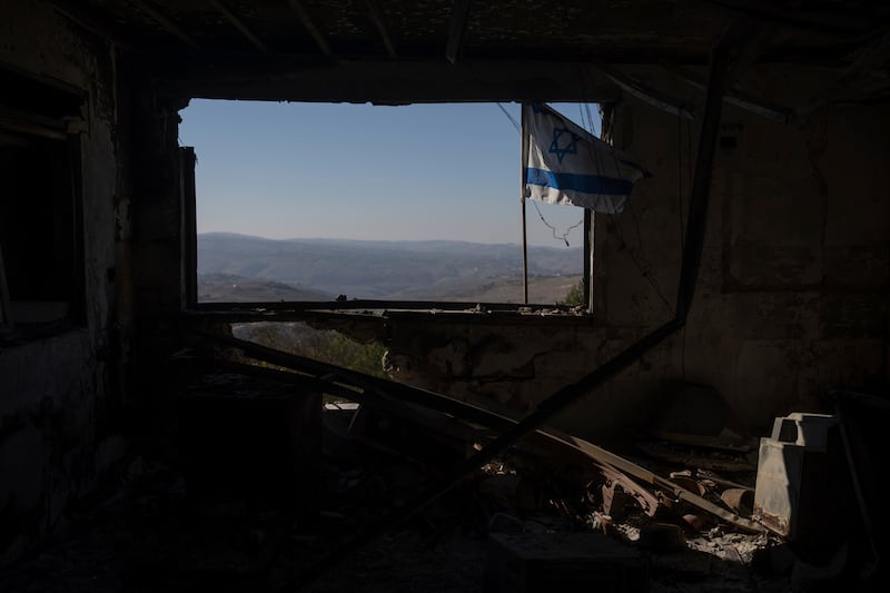 A view of a Lebanese village through a window of a damaged house that was hit by a rocket (Ohad Zwigenberg/AP)