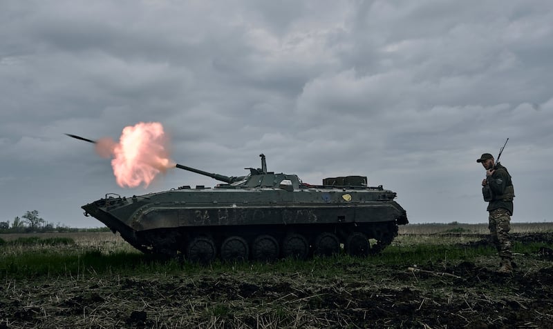 A Ukrainian APC fires towards Russian positions near Avdiivka, in the Donetsk region (AP)