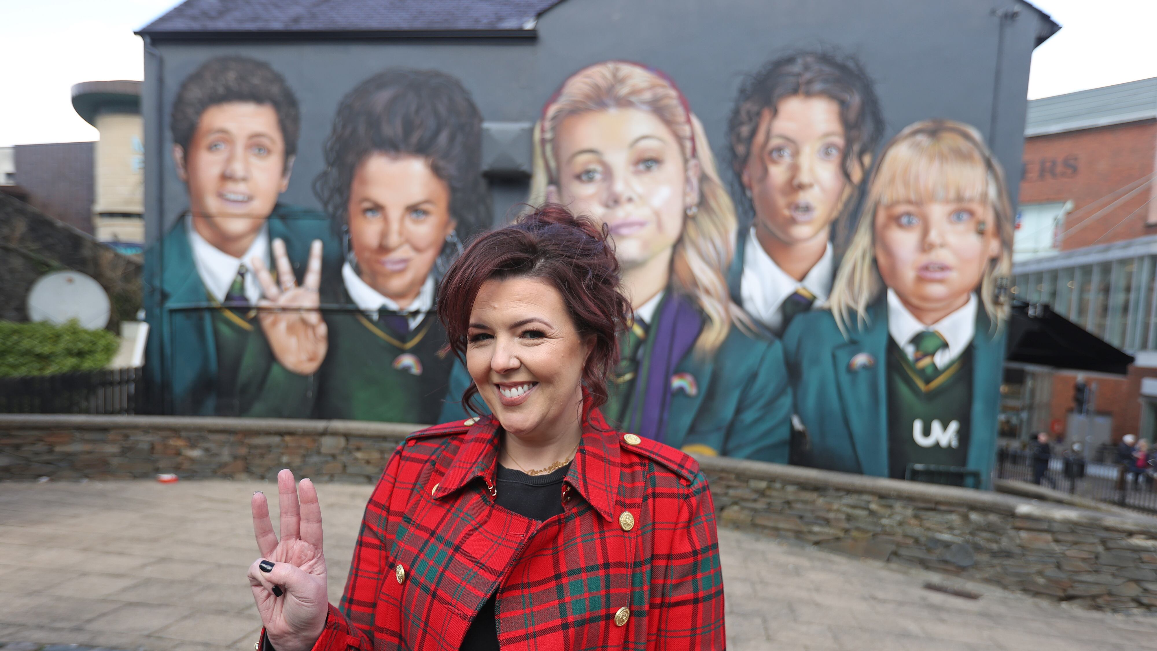 Lisa McGee in front of a Derry Girls mural in Derry