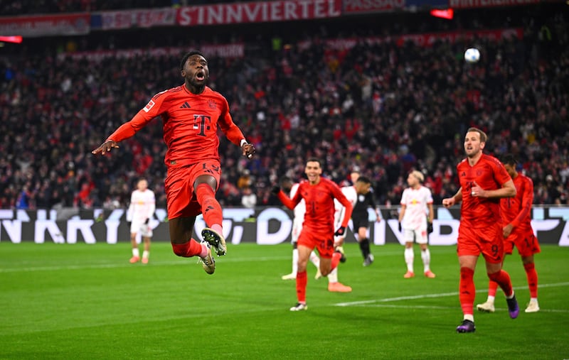 Alphonso Davies, left, celebrates scoring Bayern’s fifth (Tom Welle/dpa via AP)