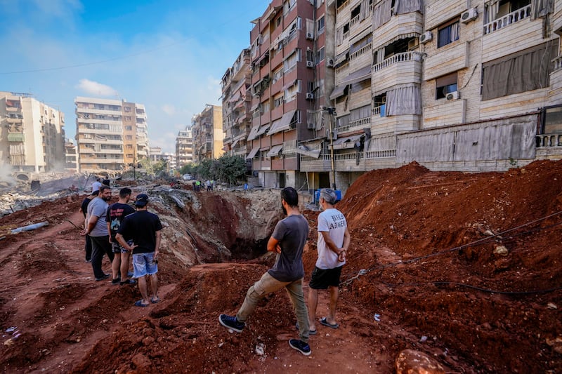 People gather at the site of the assassination of Hezbollah leader Hassan Nasrallah in Beirut’s southern suburbs (AP Photo/Hassan Ammar)