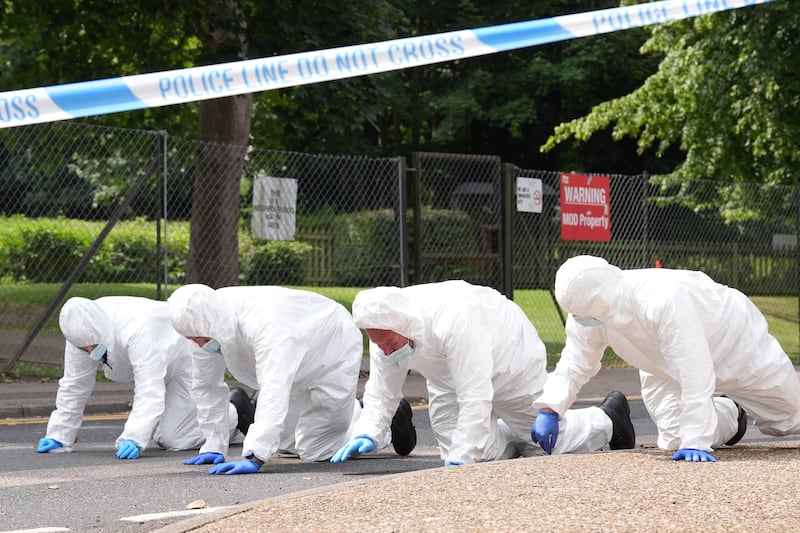 Forensic officers search the scene in Sally Port Gardens in Gillingham on Wednesday