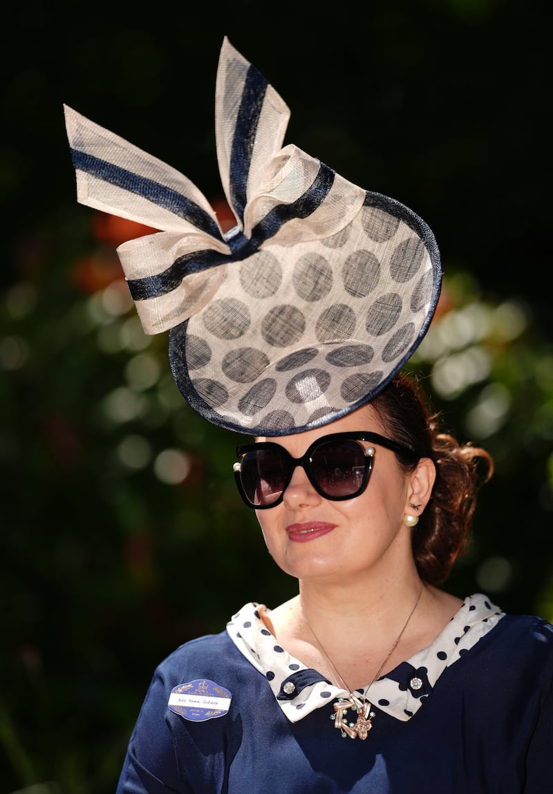 Milliner Anna Gilder wears her own design dressed with polka dots and a large bow