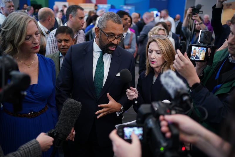 Tory leadership candidate, James Cleverly and his wife Susie are surrounded by media and party members after taking part in a Q & A at the Conservative Party Conference at the International Convention Centre in Birmingham. Picture date: Tuesday October 1, 2024. PA Photo. See PA story POLITICS Tories. Photo credit should read: Jacob King/PA Wire