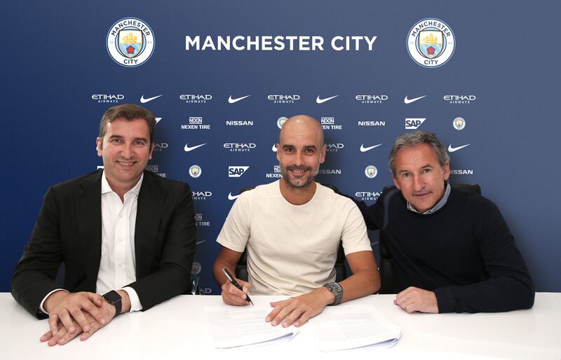 Guardiola (centre) has only signed short contracts during his reign